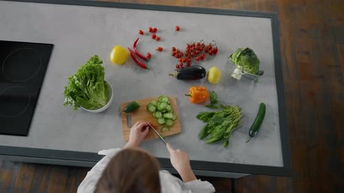 Female Chef Cutting Vegetables on Table Professional Woman Chef Chopping Vegetables on a Cutting