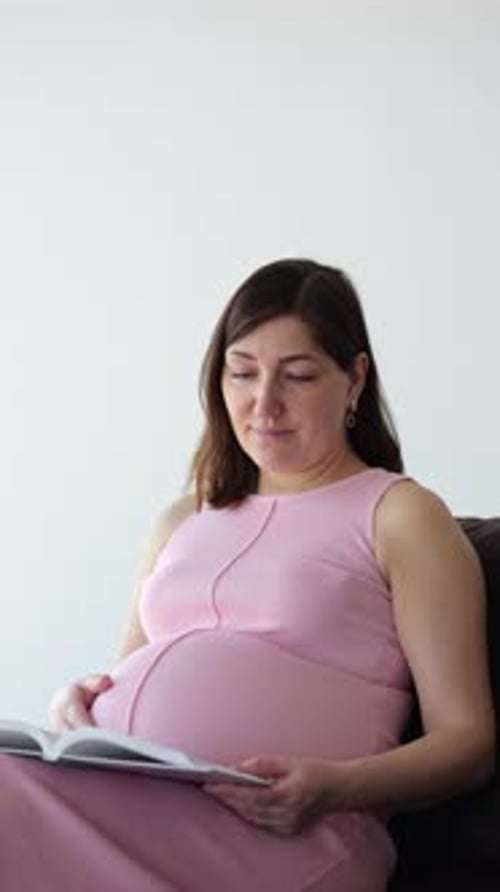 Pregnant Woman Reading a Book on White Background