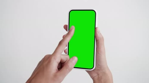 Young Person Use Smartphone With Green Screen Chroma Key Close-Up. Girl Hold In Hand Clicking Cel...