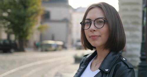 A Girl is Smiling on the Street Cute Lady in Glasses is Smiling on the Street Closeup