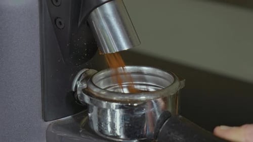 Espresso Machine Grinding Coffee Into Portafilter