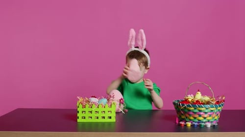 Joyful Young Kid Playing Around with Festive Painted Decorations