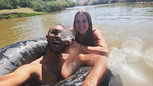 Selfie, swimming and couple in lake in nature live streaming on holiday, vacation and weekend