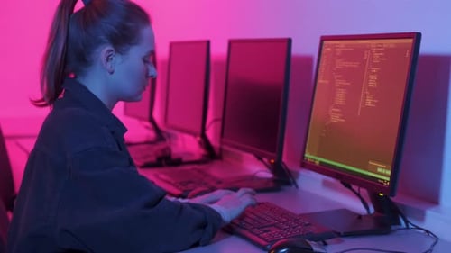 Young Beautiful Woman Working in an Office in a Dark Room