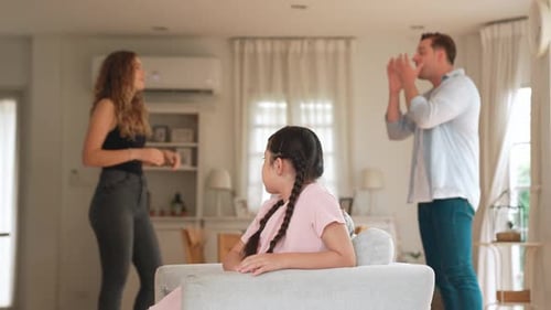 Child Observes Parents During Disagreement in Home Living Room