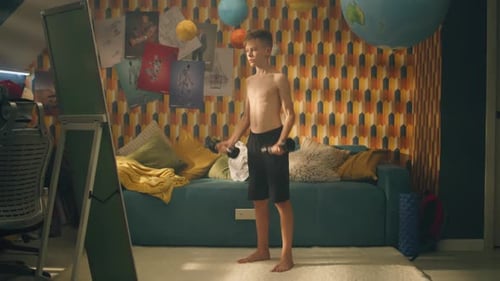 Teenage Boy Do Dumbbells Curls in Front of the Mirror School Sports Competition