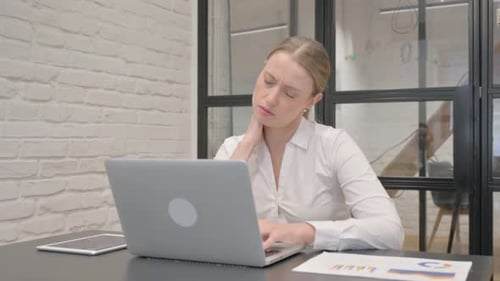 Woman Working on Laptop in Bright Office
