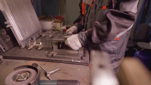 Machinist Working with Industrial Tools on Metal