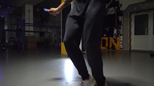 Male Feet of Athlete Skipping with a Jump Rope at Sport Club Legs of Young Sportsman Exercising at