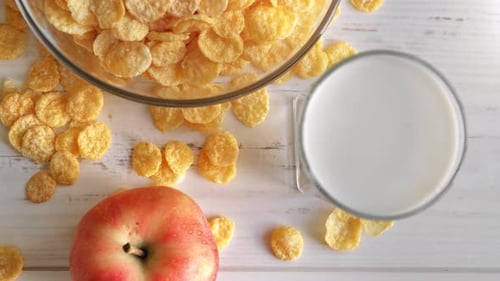 Fitness Morning Food Healthy Diet Breakfast Milk Corn Flakes and Apple Wooden Rustic Table Top View