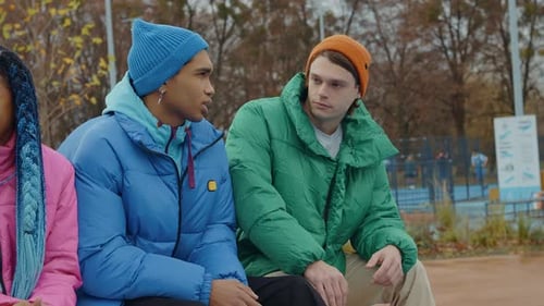 Two Young Adults Talking in City Park