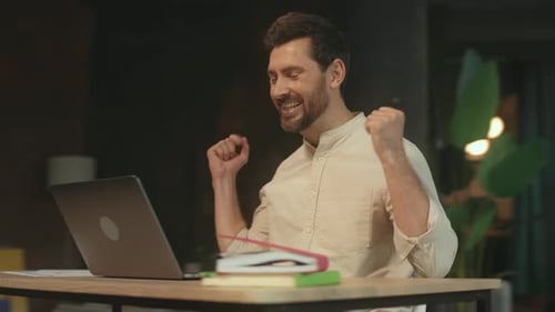 Success Businessman Sitting at Desk Use Laptop Look on Screen Smiling and Dance in Office Satisfied