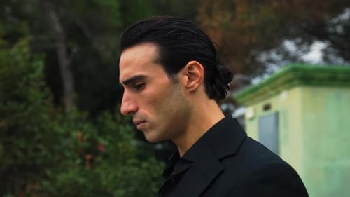 Serious Man in a Black Suit Outdoors