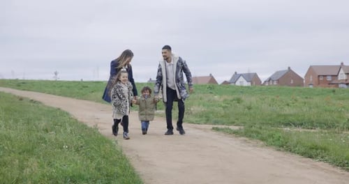 Happy multiracial family having a walk together at park