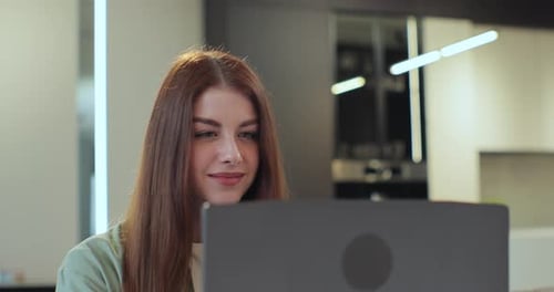 Woman Using Laptop in Bright Home Interior