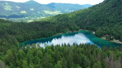 Picturesque lake Lago Fusine in Italy. Fusine lake with Mangart peak on background. Popular travel d