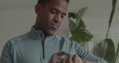 African American Male getting ready for a Run checking his Smartwatch