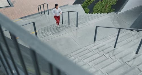 Fitness, challenge and woman running on stairs from above for training, workout or cardio