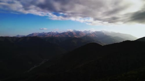Sunrise Or Sunset In Mountains Aerial Shot Dark Mountain Range And Beautiful White Clouds