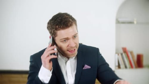 Man Talking on Phone in Office