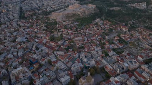 High aerial shot over old town Athens and the Acropolis at dawn