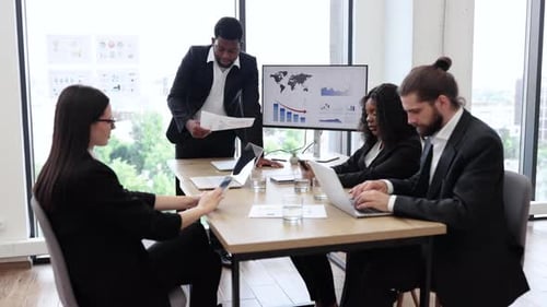 Business Meeting Presentation in Modern Office with Charts and Graphs