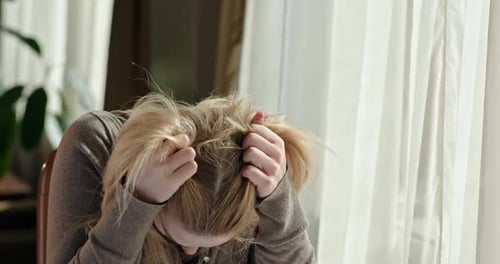 Sad Woman Contemplates Next to Window
