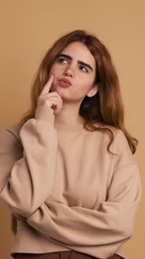 Young Woman Thinks, Suddenly Has Idea, Smiling