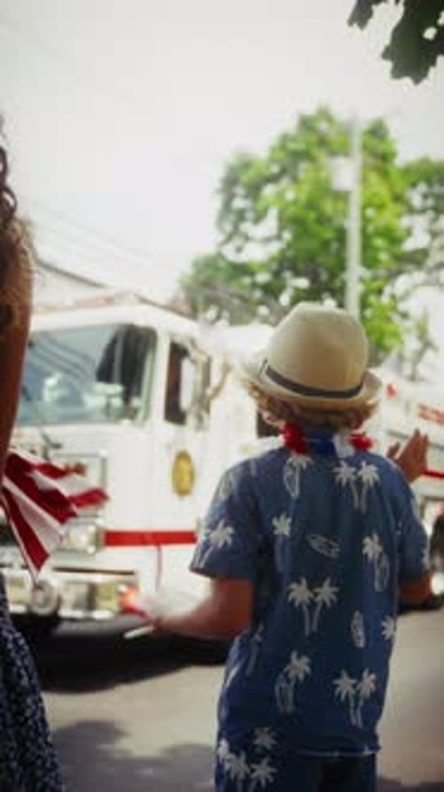 Child Holding American Flag at Fourth of July Parade