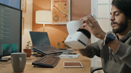 Software Engineer Using AR Headset while Writing Computer Code