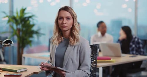 Woman Works on Tablet in Modern Office