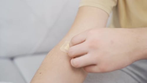 Applying a bandage on arm for wound care