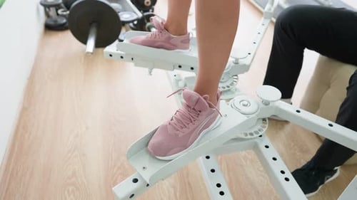 Young Adult Exercising on Leg Machine in Gym