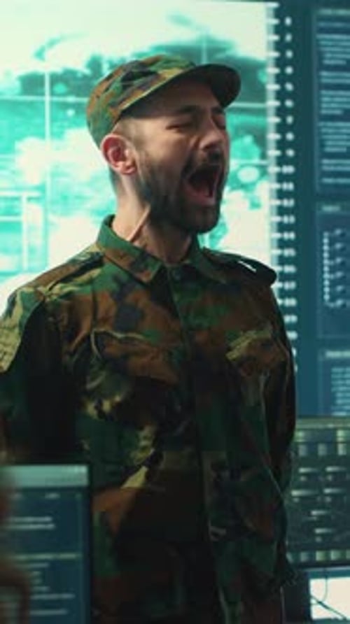 Military Officer in Camouflage Shouting in Command Center