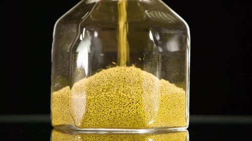 Hourglass with Gold Balls Filling Up Glass