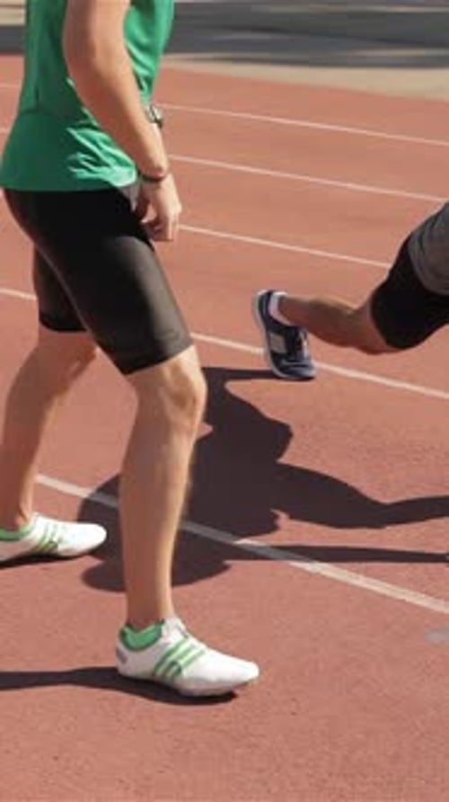 Two Athletes Warm Up at the Stadium