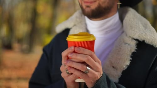 Young Adult Drinking Coffee Outside