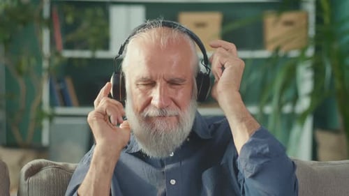 Senior Man Listening to Music on Headphones