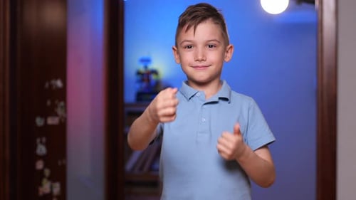 Elementary School Student Boy Smiles and Shows a Gesture of Class Like Success