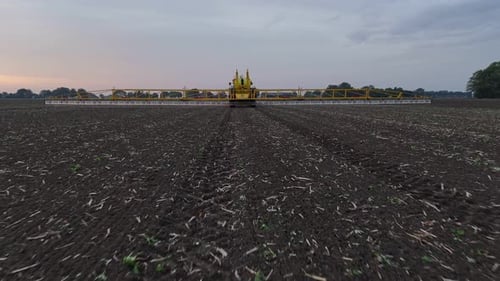 Tractor Spraying On Field With Sprayer, Herbicides And Pesticides