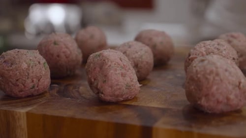 Fresh meat balls on wooden cut board. Close up shot.