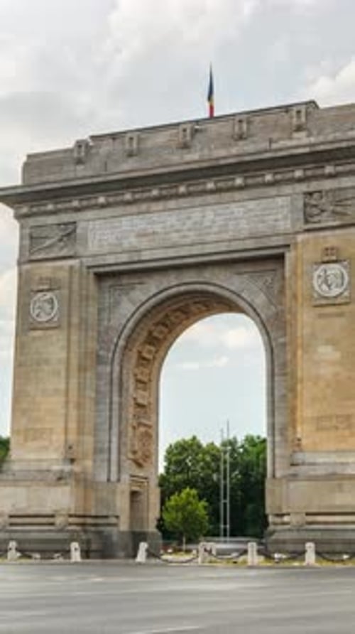 Time lapse of cars moving near the Triumphal Arch of Bucharest, Romania. Vertical