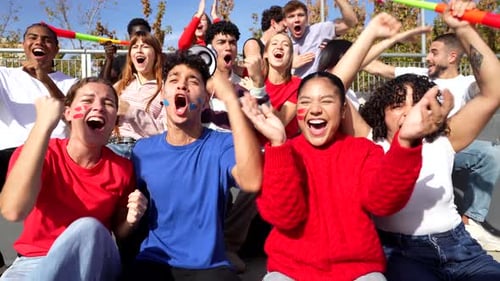 Excited Group of Friends Cheering at a Sports Stadium Event