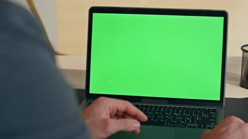 Worker Hand Scrolling Touchpad Green Screen Laptop at Modern Workplace Closeup