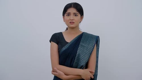 Woman Wearing Sari Looks Around Thoughtfully