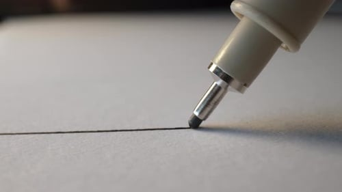 Technical Pen Draws Precise Straight Line on Paper
