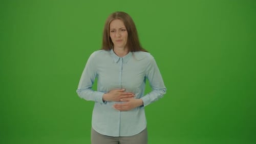 Green Screen. Chroma Key. Unhealthy Woman in Blue Shirt Feeling Abdominal Pain, Suffering Heartburn,