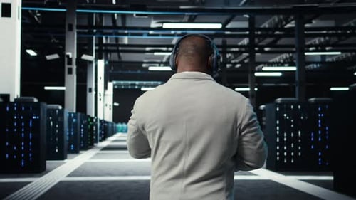 Admin Walking in Data Center Listening Music While Doing Inspection