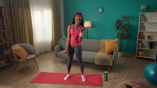 Woman Working Out at Home with Dumbbells