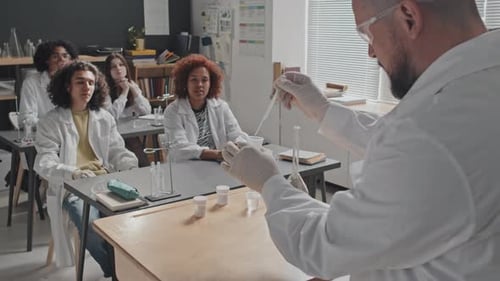 Teacher Leads Chemistry Experiment for Eager Students